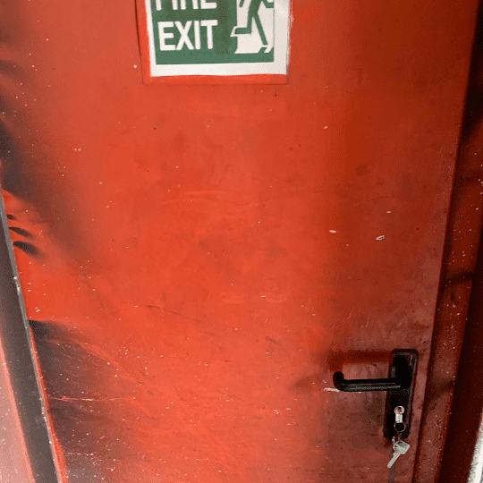 industrial fire door exit with broken lock